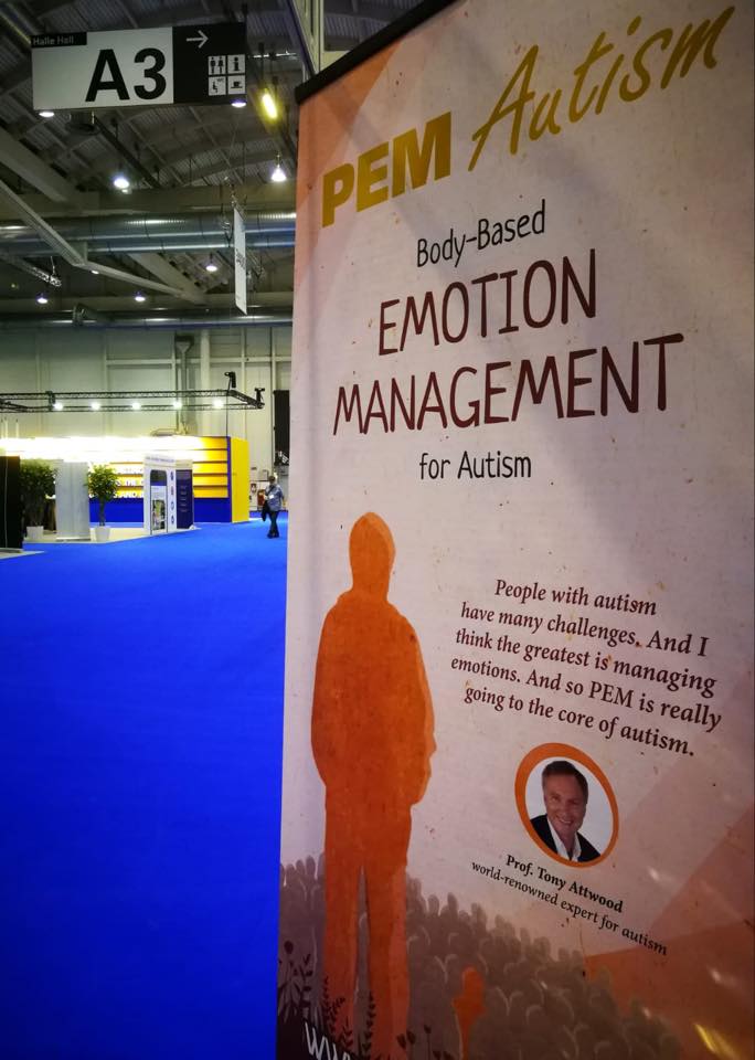 An image of a tall poster describing PEM Autism and Emotion Management at a conference