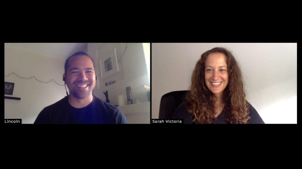 A man and a woman smiling on a conference call